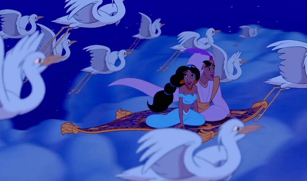 Princess Jasmine and Aladdin riding the magic carpet in the animated movie "Aladdin"