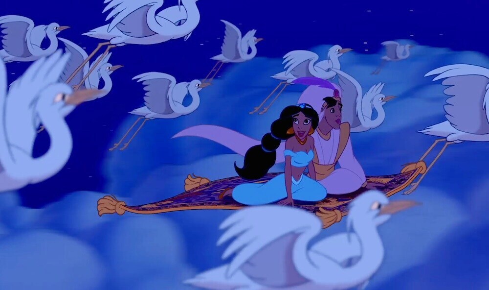 Principessa Jasmine e Aladdin cavalcando il tappeto magico nel film d