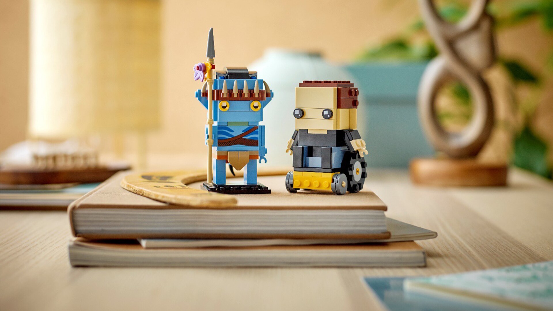 Image of LEGO Avatar Jake Sully & his Avatar set on the desk with the books and notepads