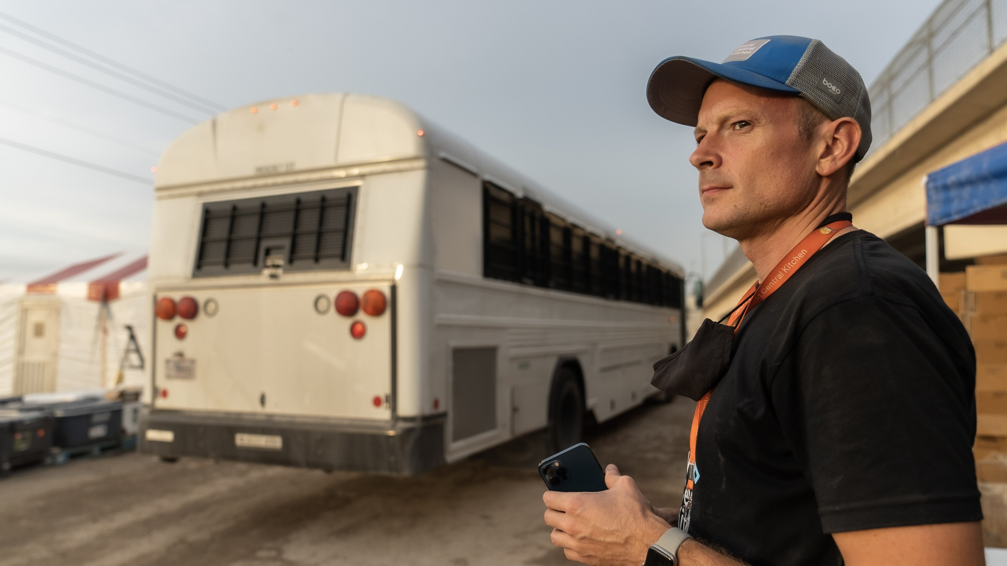 World Central Kitchen CEO, Nate Mook, watches as buses full of Haitian Migrants are shuttled to deportation holding areas in Texas. (Credit: National Geographic/Michael Atwood)
