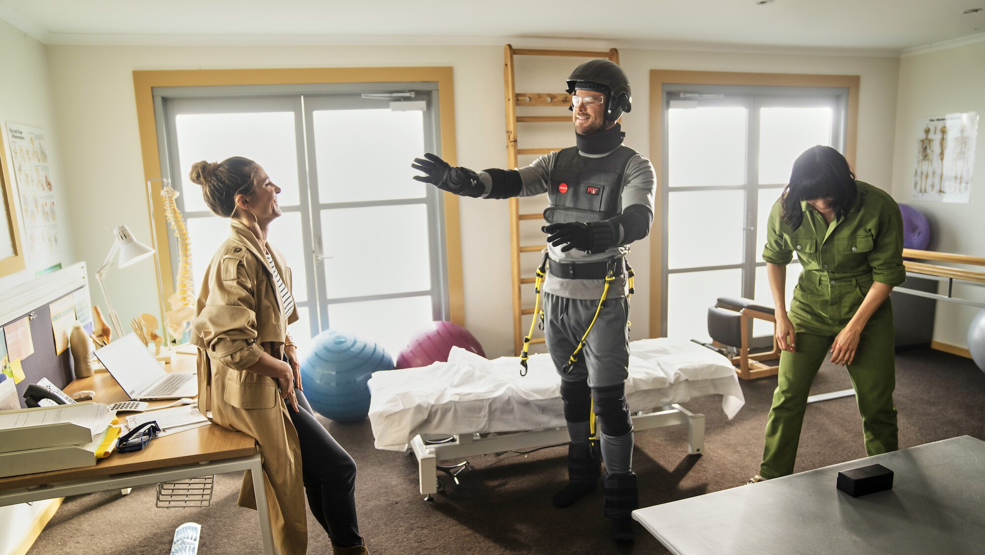 Chris Hemsworth tries on an age simulation suit with his wife, Elsa. (National Geographic for Disney+/Craig Parry)