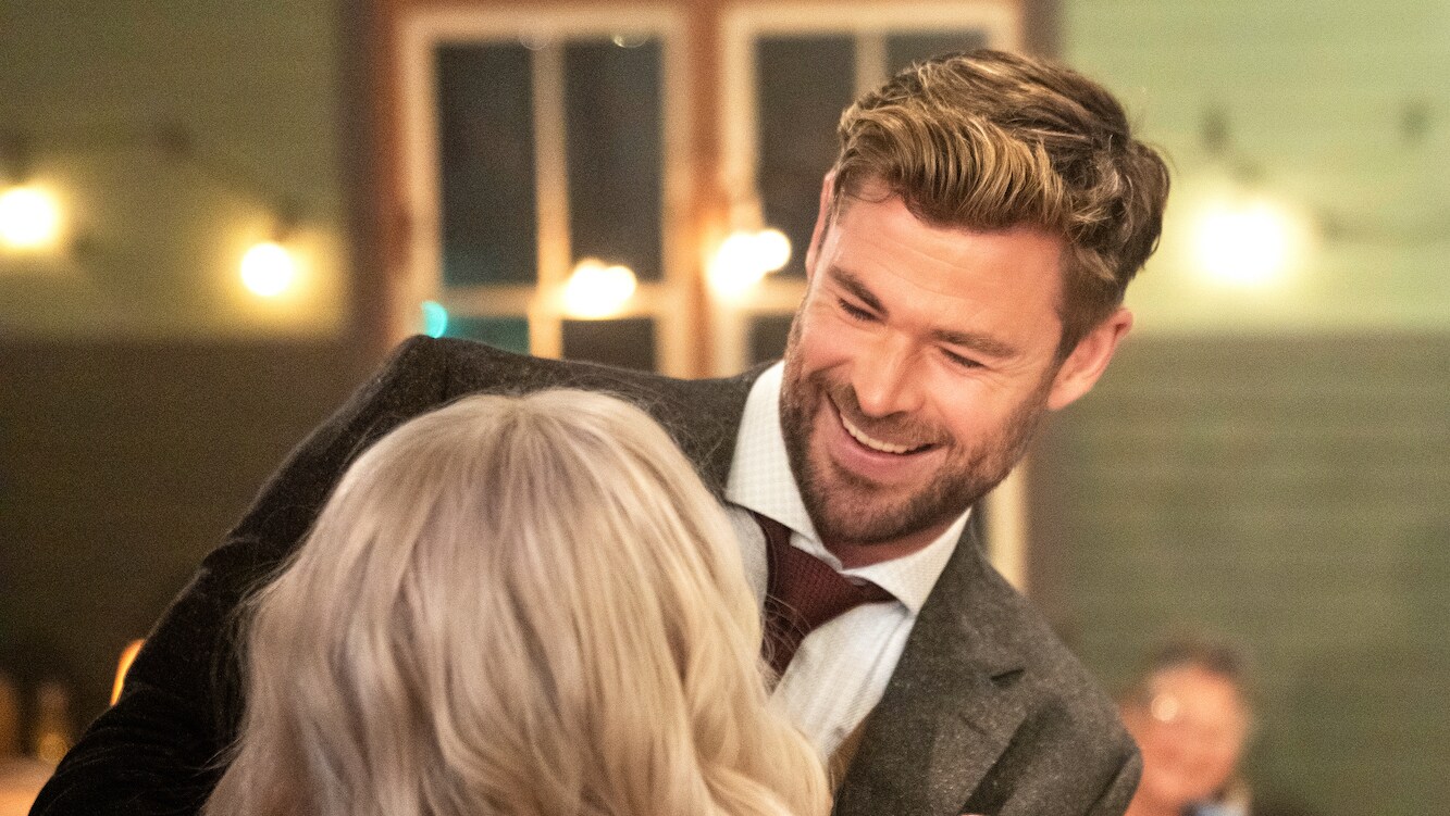Chris Hemsworth greets his date for the dance. Elsa surprises him by wearing prosthetics to age her 50 years. (National Geographic for Disney+/Craig Parry)