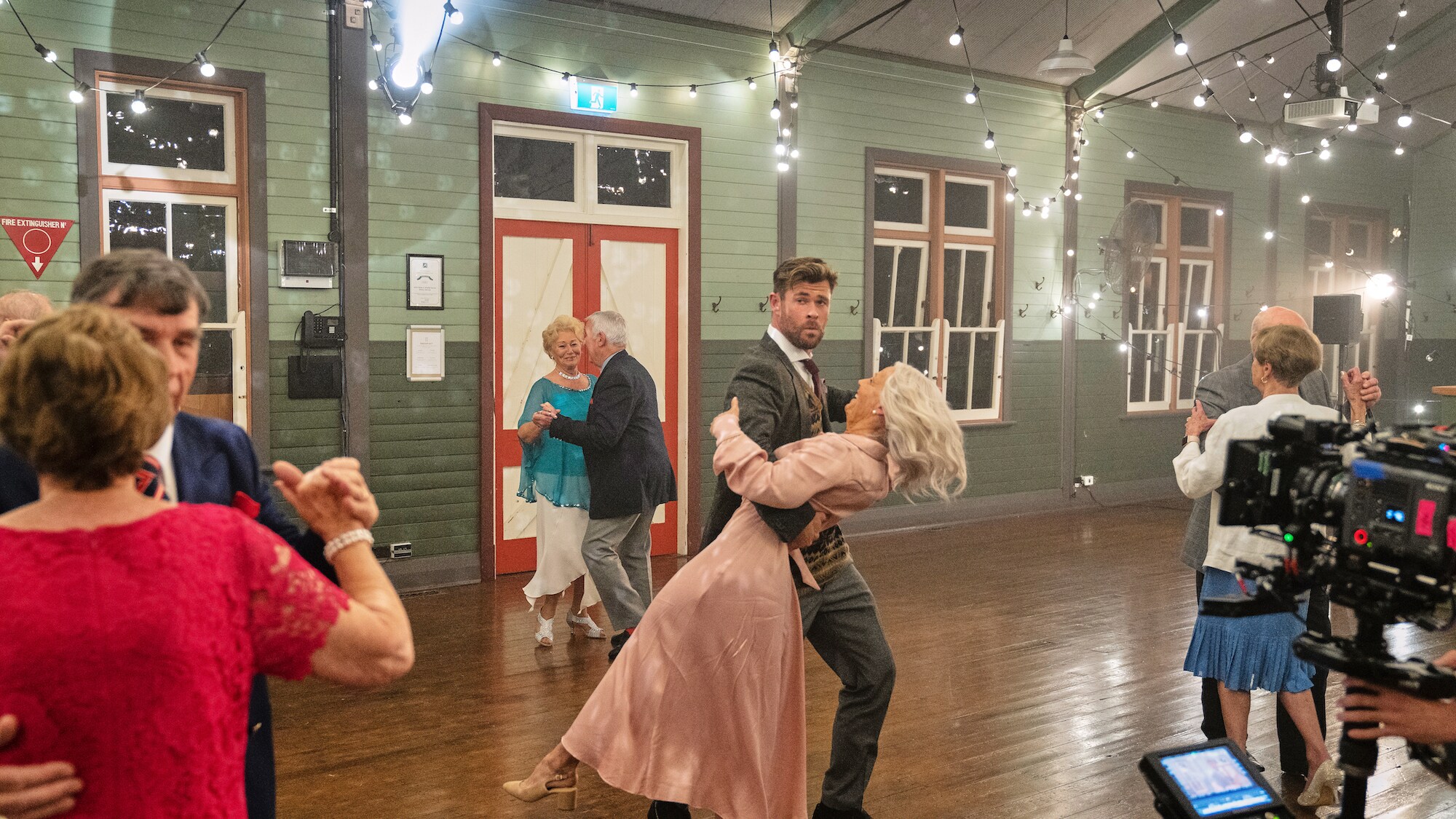 Chris Hemsworth and Elsa dance with other residents. (National Geographic for Disney+/Craig Parry)