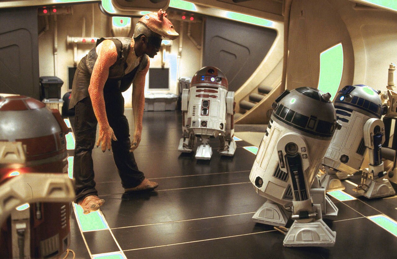 Ahmed Best on set surrounded by droids