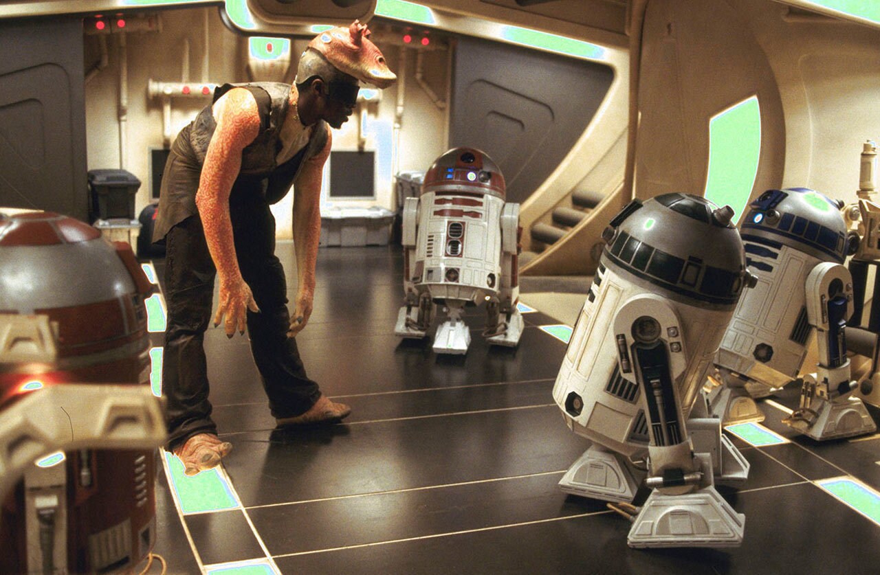 Ahmed Best on set surrounded by droids