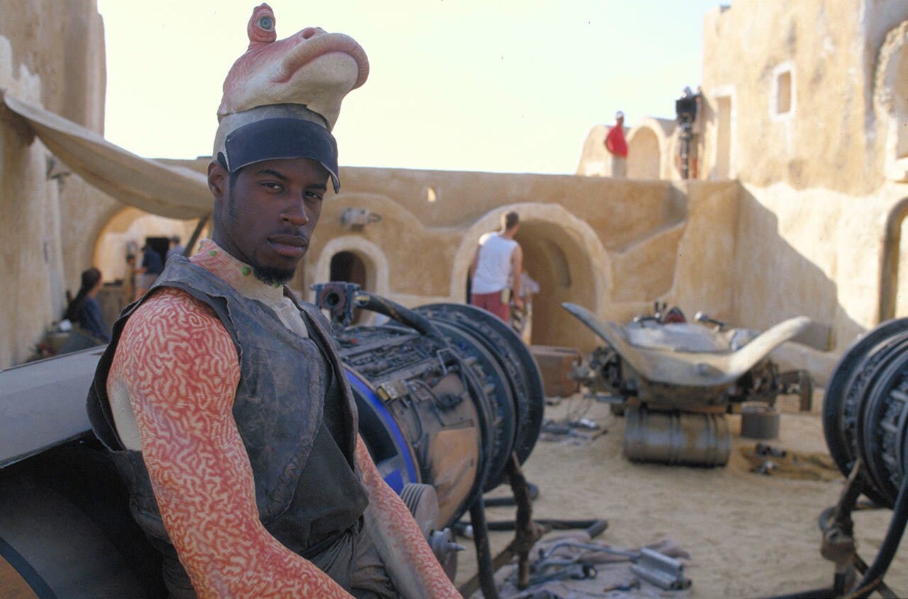 Ahmed Best sitting on a podracer on the set of The Phantom Menace.