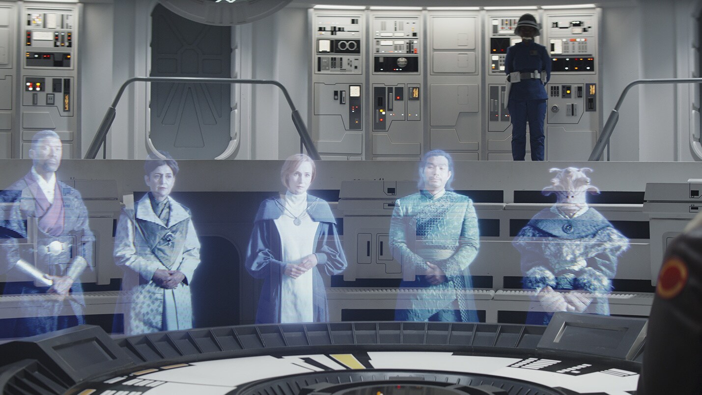 Aboard Home One, Hera appears before a hologram of the New Republic council, briefing them on wha...