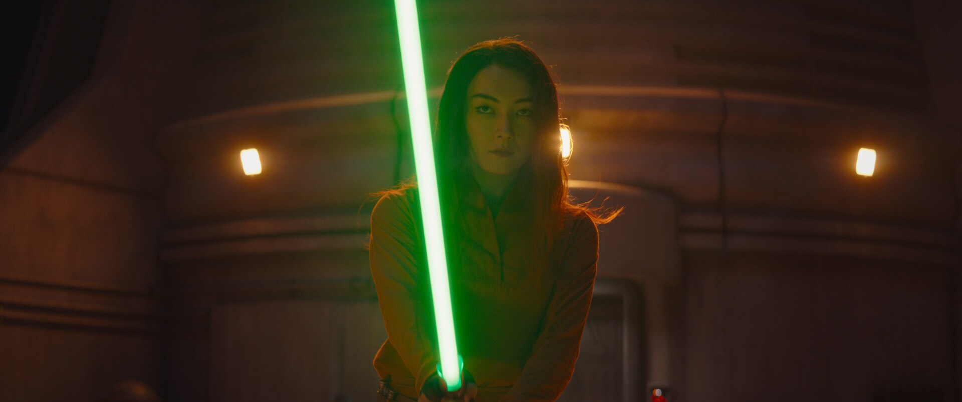 Sabine holding a green lightsaber