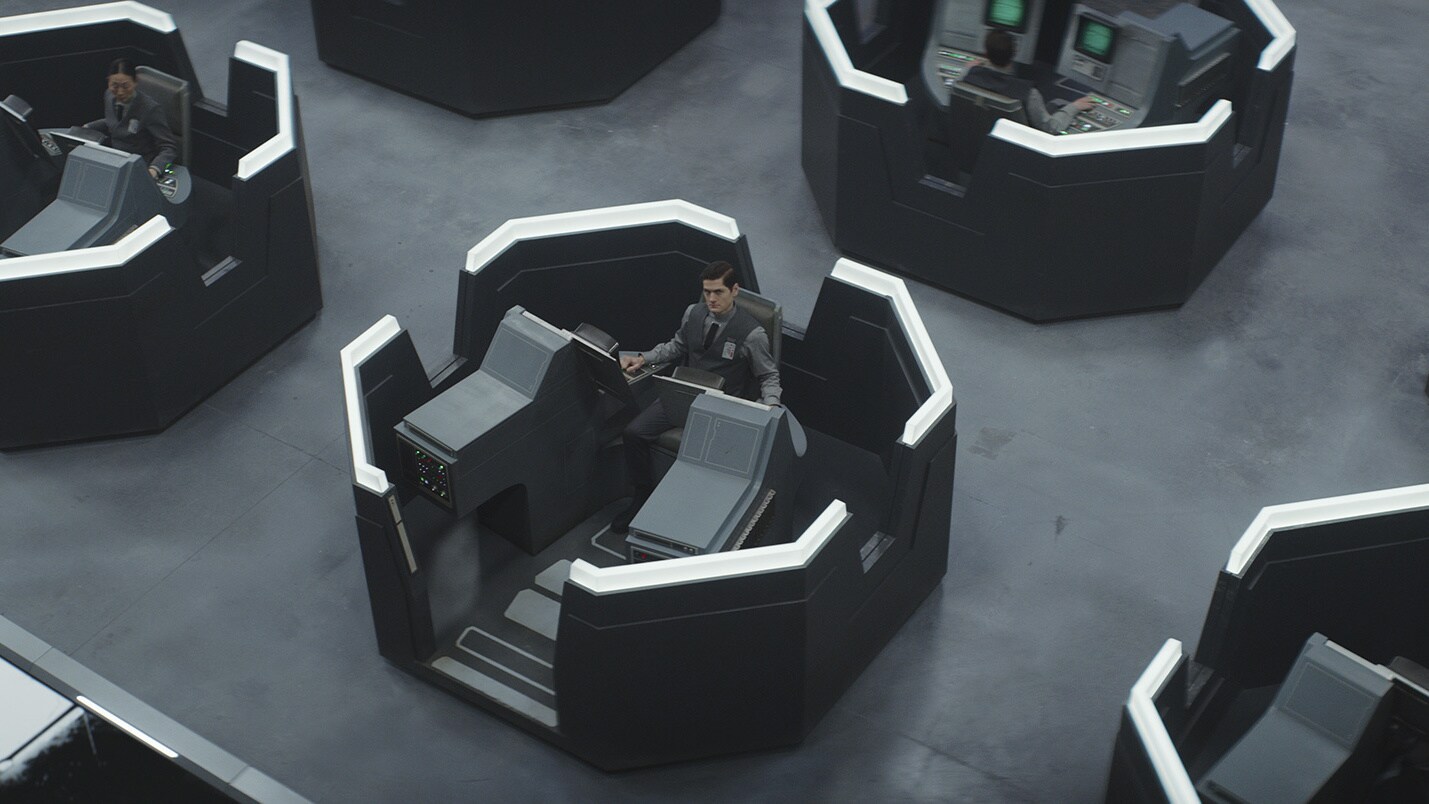 Meanwhile, Syril sits at his desk in his new job -- one of many scanning data. 