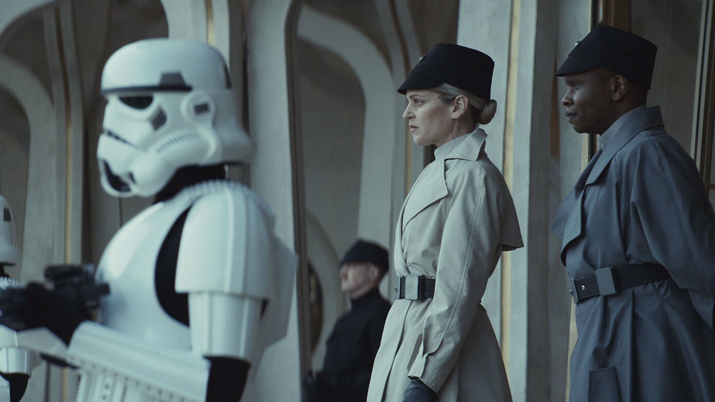 (Second from Left - R) Dedra Meero (Denise Gough) and Grymish (Kurt Egyiawan) in Andor season 2.