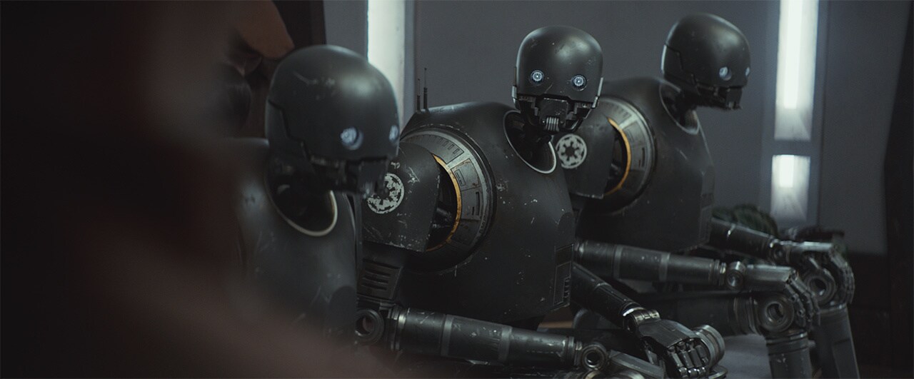 Syril enters a room of multiple KX droids.