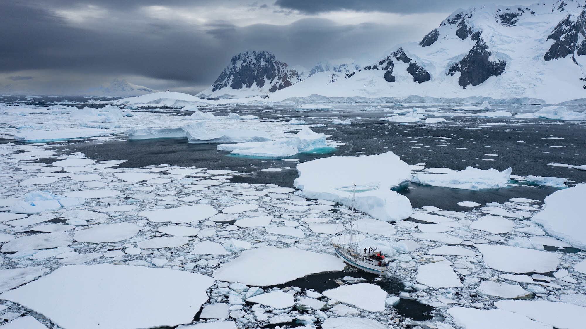 High, distant shot of the Australis sailing through the ice flow. (credit: National Geographic for Disney+/Bertie Gregory)
