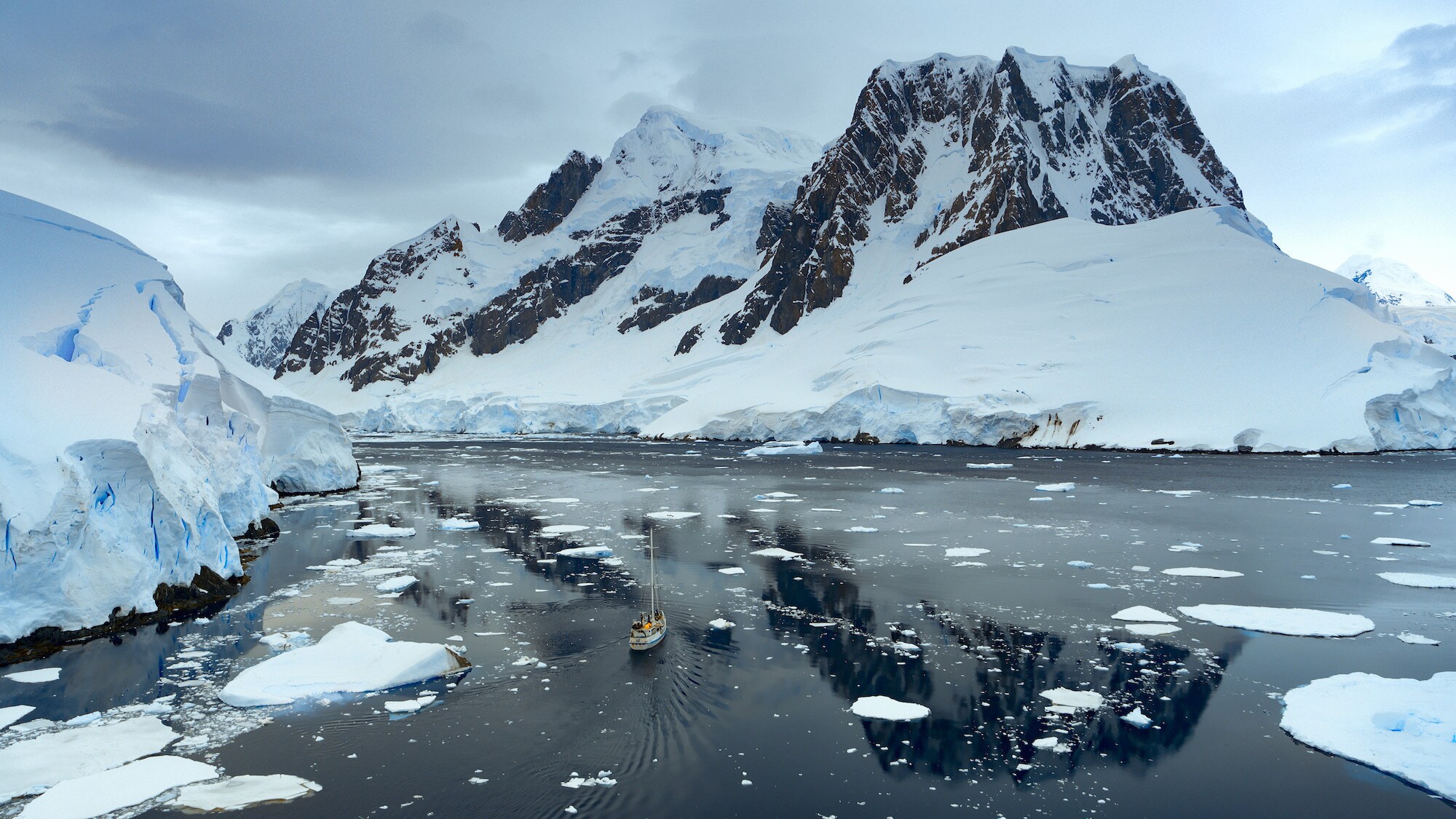 Aerial shot of the Crew on board the Australis amongst the ice. (credit: National Geographic for Disney+/Bertie Gregory)