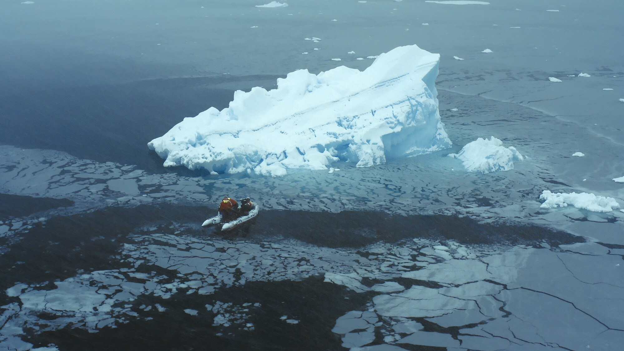 The filming crew onboard the rib moving towards an iceberg. (credit: National Geographic for Disney+/Tom Walker)