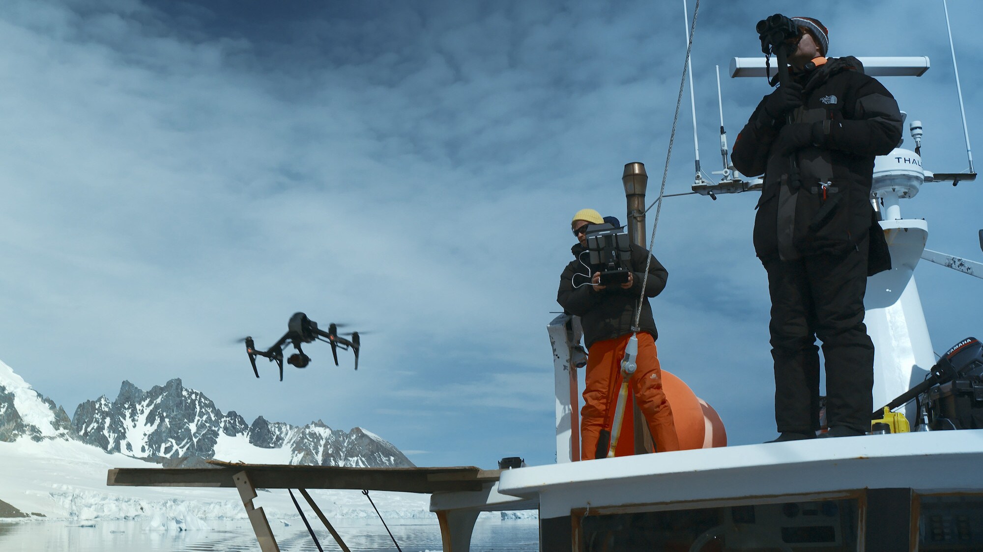 Bertie Gregory flying a drone from the side of the Australis. (credit: National Geographic for Disney+/Will West)