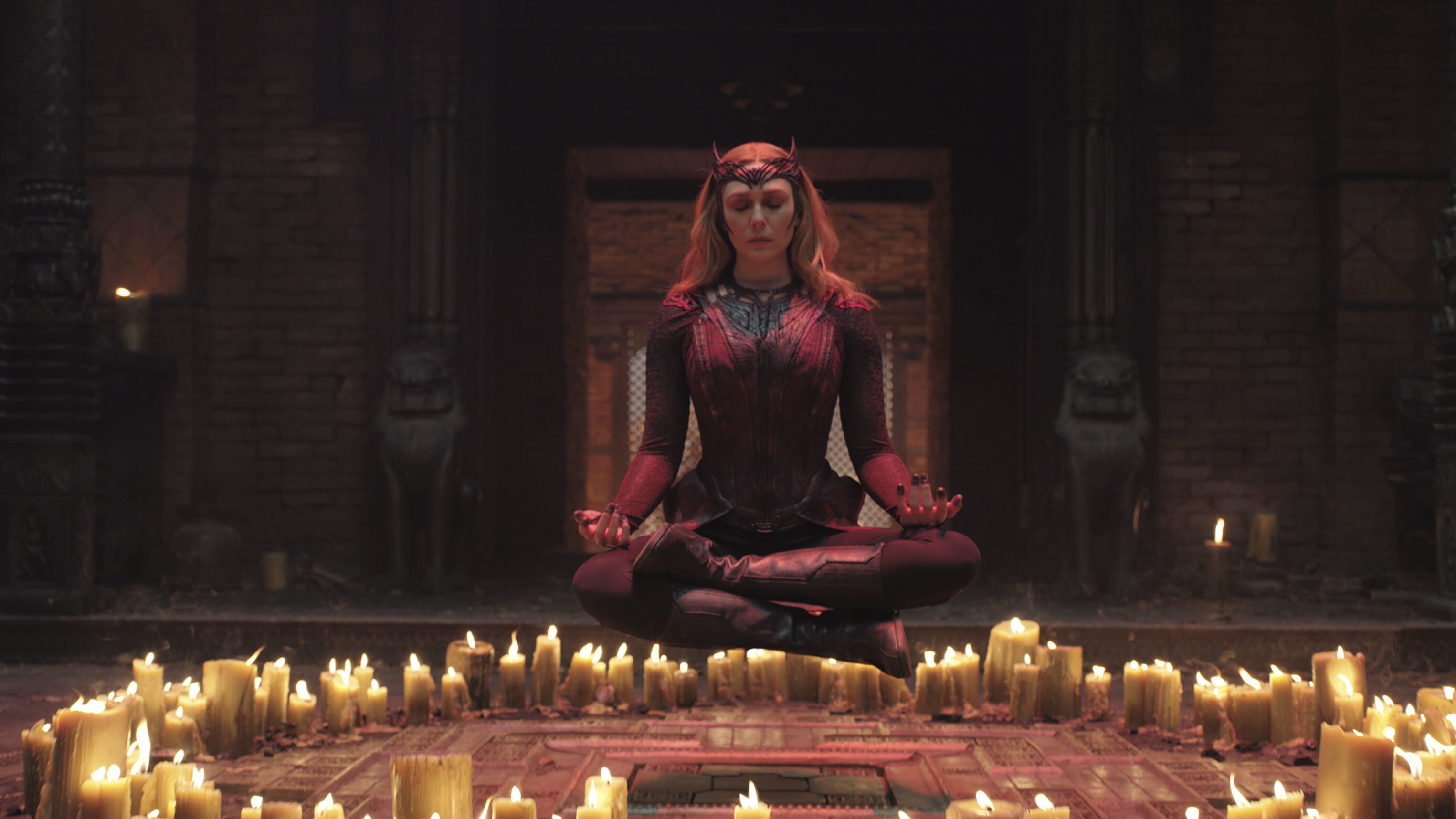 Wanda aka the scarlet witch using her magic surrounded by candles 