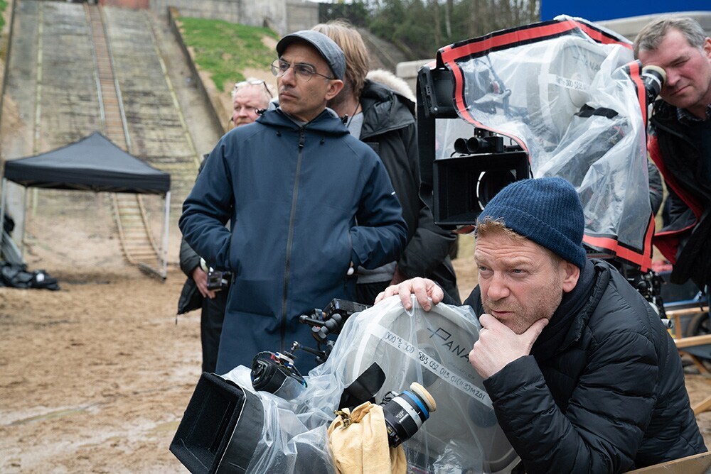 Director Kenneth Branagh with cinematographer Haris Zambarloukos in front of crew on the set outside