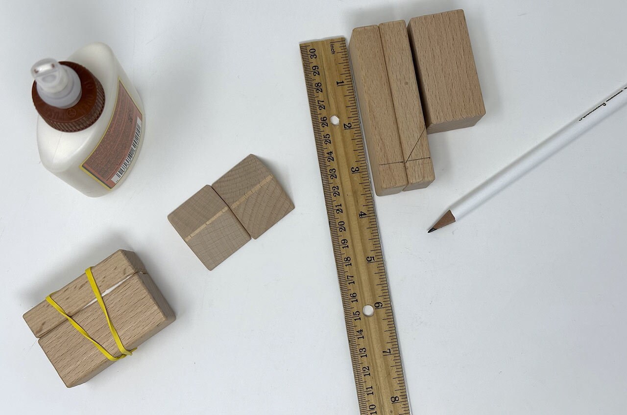 Step 6: Arrange the wood pieces for the head with the longer pieces in the front and smaller piece in the back. Measure and mark 3” down from the top on the front pieces. On the middle block, draw an angle from the corner of the small block to the 3” mark.