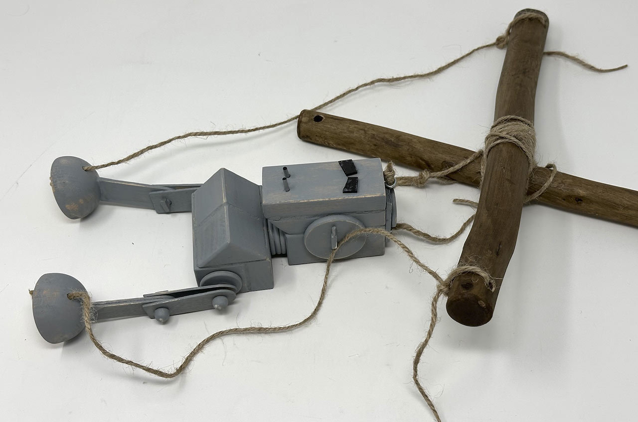 Step 33: Tie the two head strings near the center of the other stick.