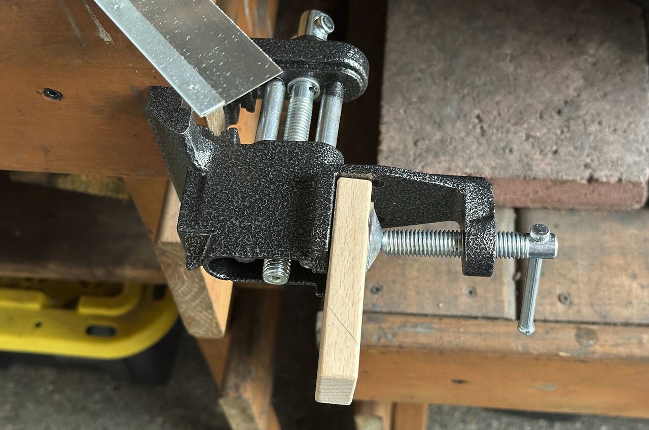 Step 7: Use a handsaw to cut the thin rectangle block without the angle, then cut the angle for the second thin block.