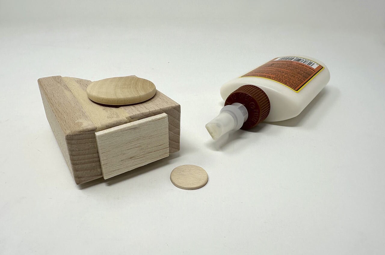 Step 15: Cut a small rectangle of thin balsa wood for the top of the AT-ST’s head. Glue it in place, then glue a small wood disc on top.