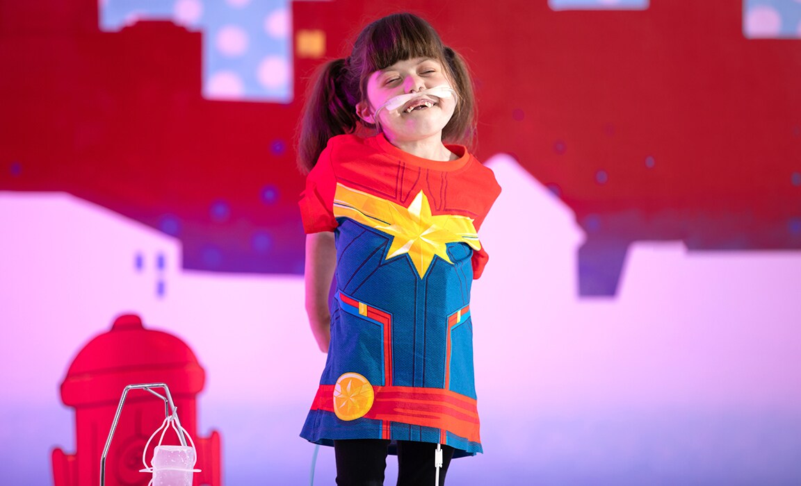 A little girl showing off her Marvel Edition 'Captain Marvel' Supertee