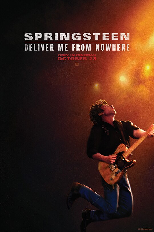 The teaser movie poster for Springsteen: Deliver Me From Nowhere showing Jeremy Allen White as Bruce Springsteen playing his guitar on stage in the rain under the glow of orange lights.
