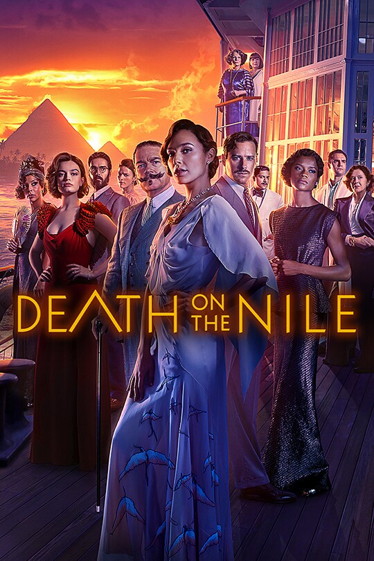 The extensive A grade celebrity cast of Death on the Nile stand next to each other, Egyptian pyramids in the background.