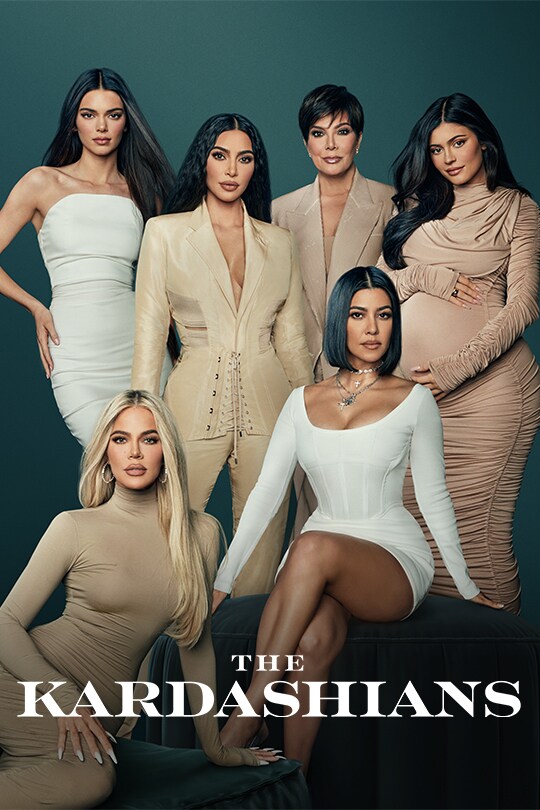 The famous reality TV stars, The Kardashian family sit and stand next to each other.