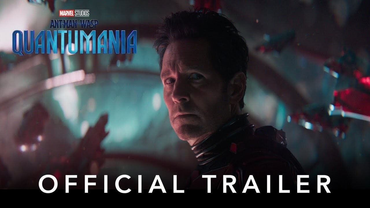 A thumbnail for Ant-Man and the Wasp: Quantumania teaser trailer thumbnail, featuring a closeup of Paul Rudd as Scott Lang, appearing to be inside a ship with colourful background.