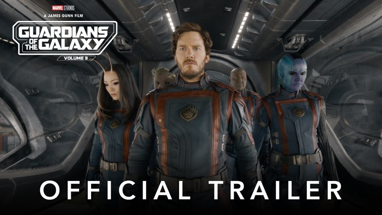An image of the cast of Guardians of the Galaxy Vol. 3 in a dark ship, wearing matching uniforms.