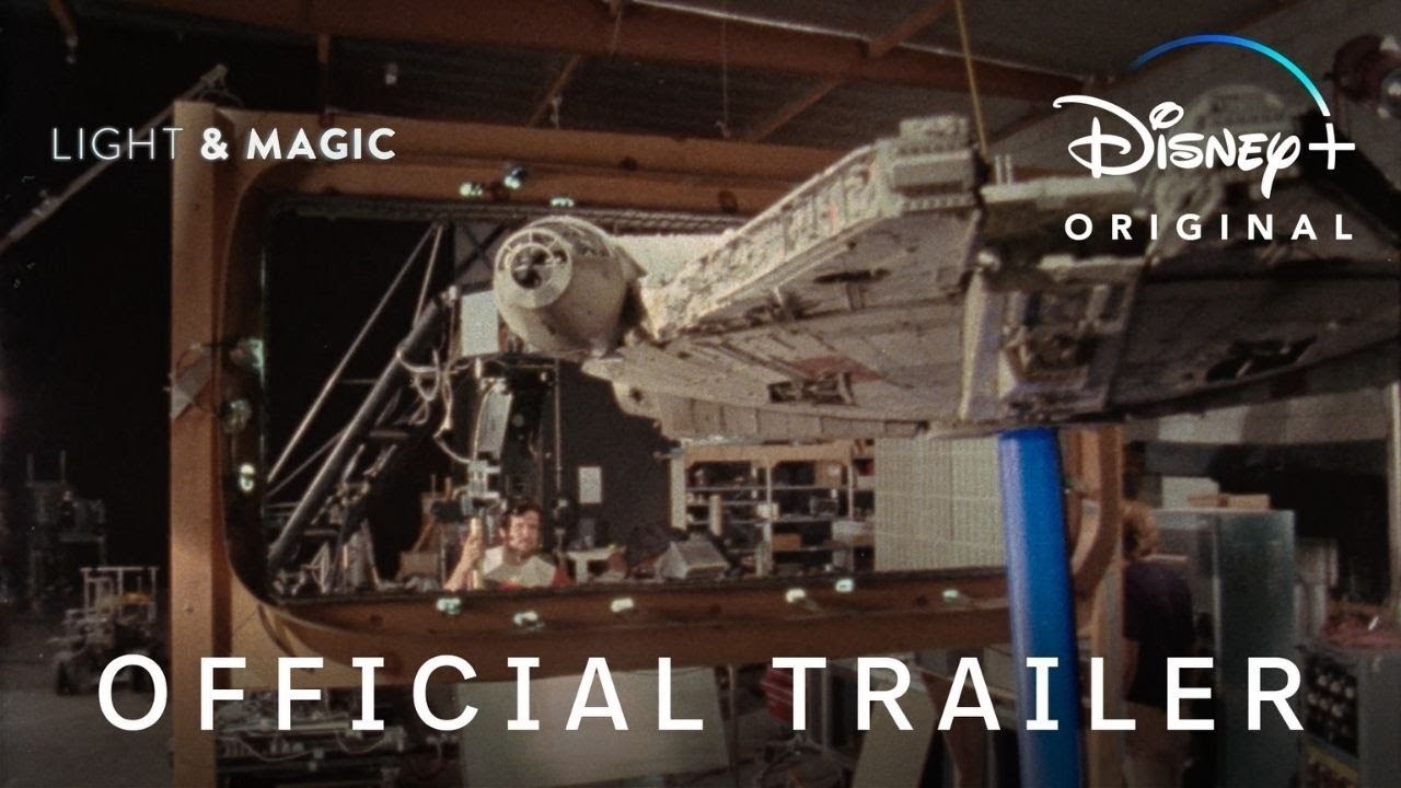 An image of crew adjusting a large model of the Millennium Falcon to be shot in Star Wars, the title 'Light & Magic' title is in the top left hand corner, 'Disney+ Original' in the top right and 'Official Trailer' text in the foreground.