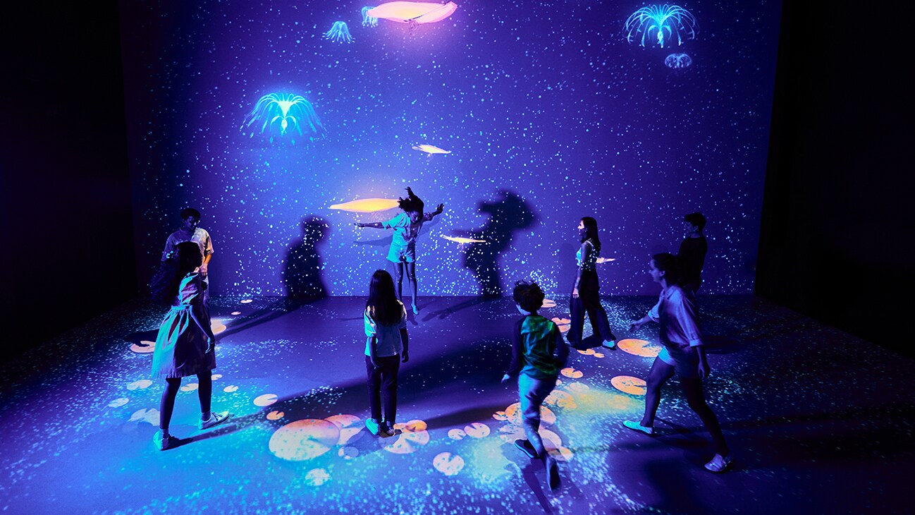Visitors and children interact with a Metkayina installation.