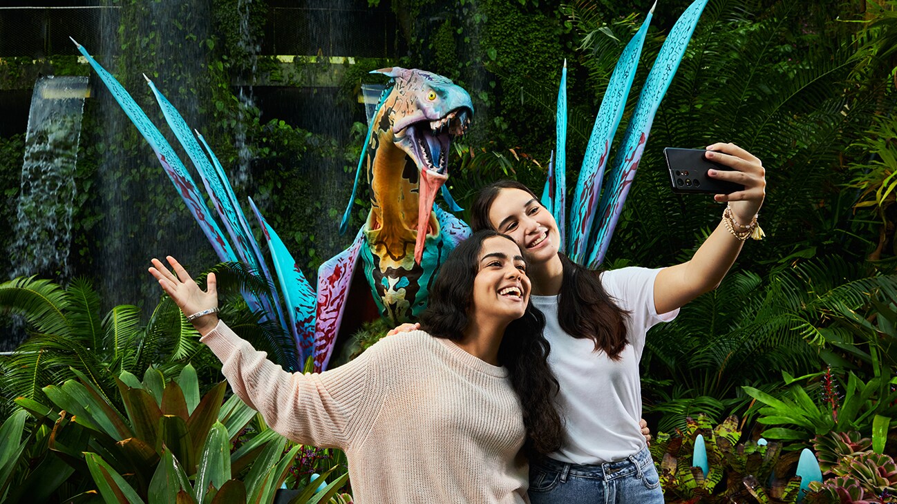 Visitors pose for a photograph with a life-size banshee model.