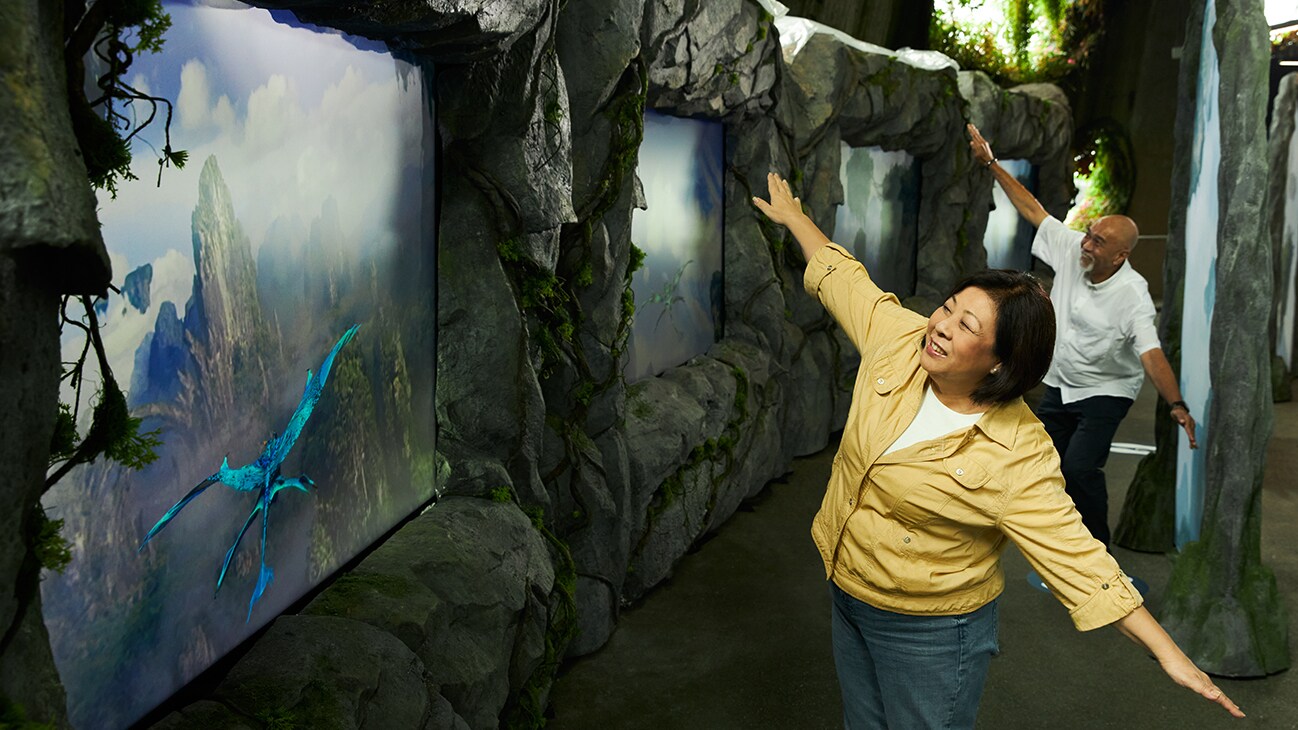 Visitors interact with a banshee flight simulation. 