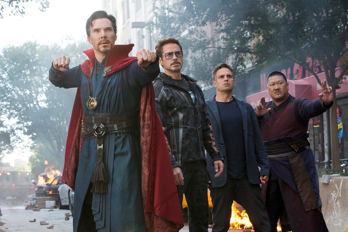 Doctor Strange, Iron Man, Bruce Banner, and Wong stand together in a scene from Avengers: Infinity War. 