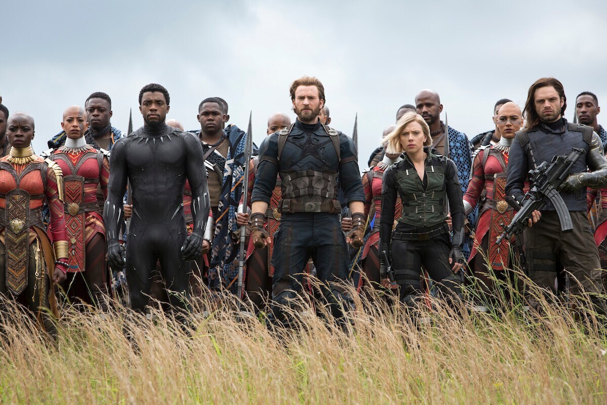 Black Panther, Captain America, Black Widow, and the Winter Soldier stand in a field in Wakanda in a scene from Avengers: Infinity War.