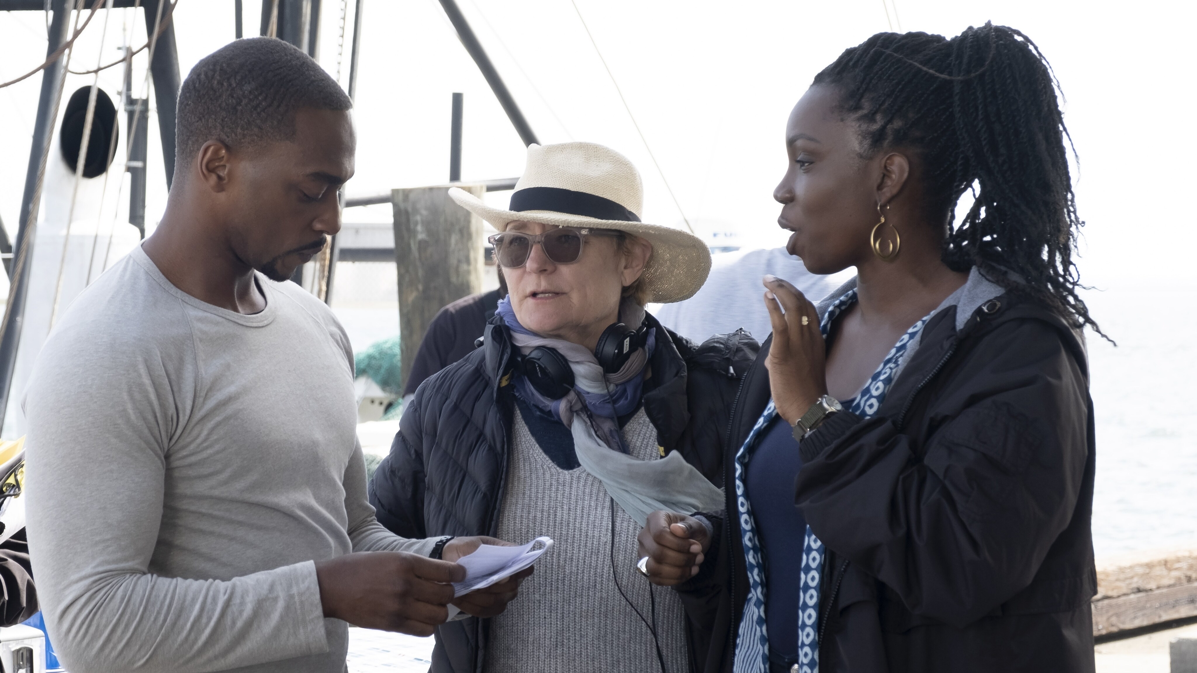 (L-R): Falcon/Sam Wilson (Anthony Mackie), Director Kari Skogland and Sarah Wilson (Adepero Oduye) on the set of Marvel Studios' THE FALCON AND THE WINTER SOLDIER exclusively on Disney+. Photo by Chuck Zlotnick. ©Marvel Studios 2021. All Rights Reserved.