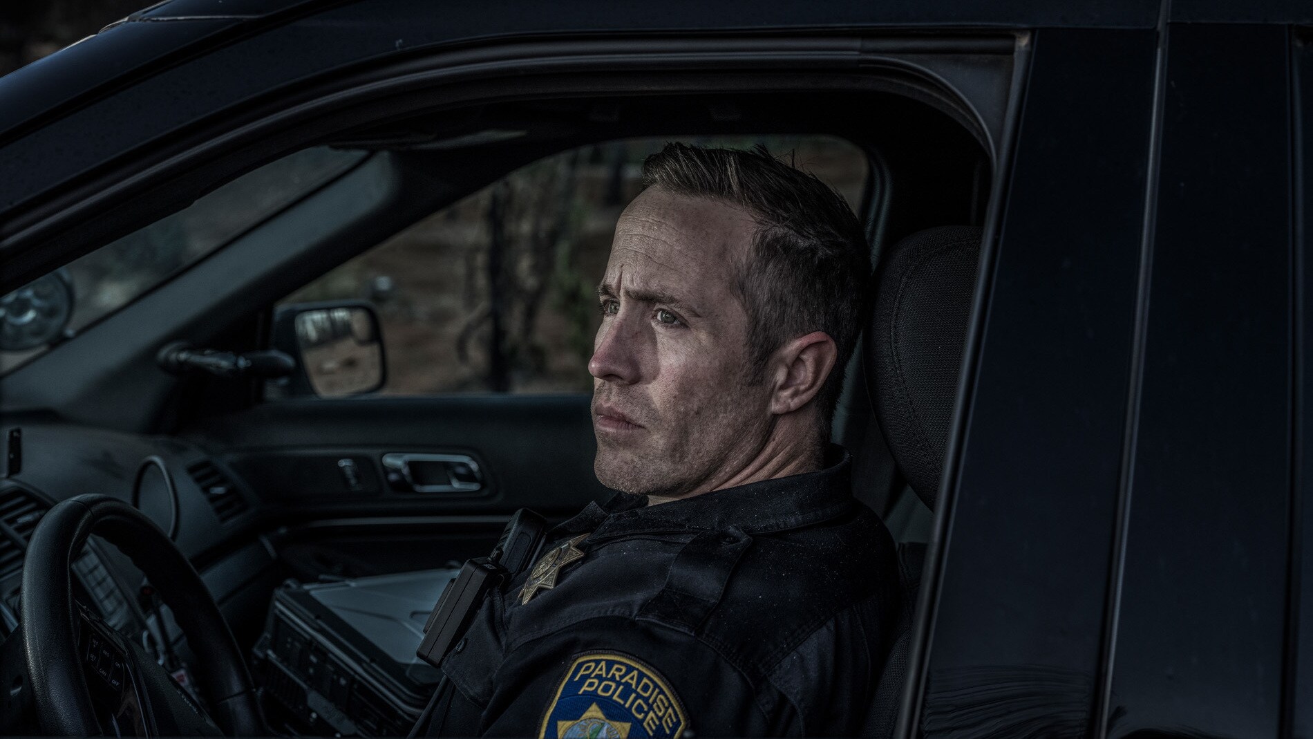 Officer Matt Gates sits for a portrait in the burned out area in Paradise, CA, to which he often responded to distress calls. (National Geographic/Pete Muller)