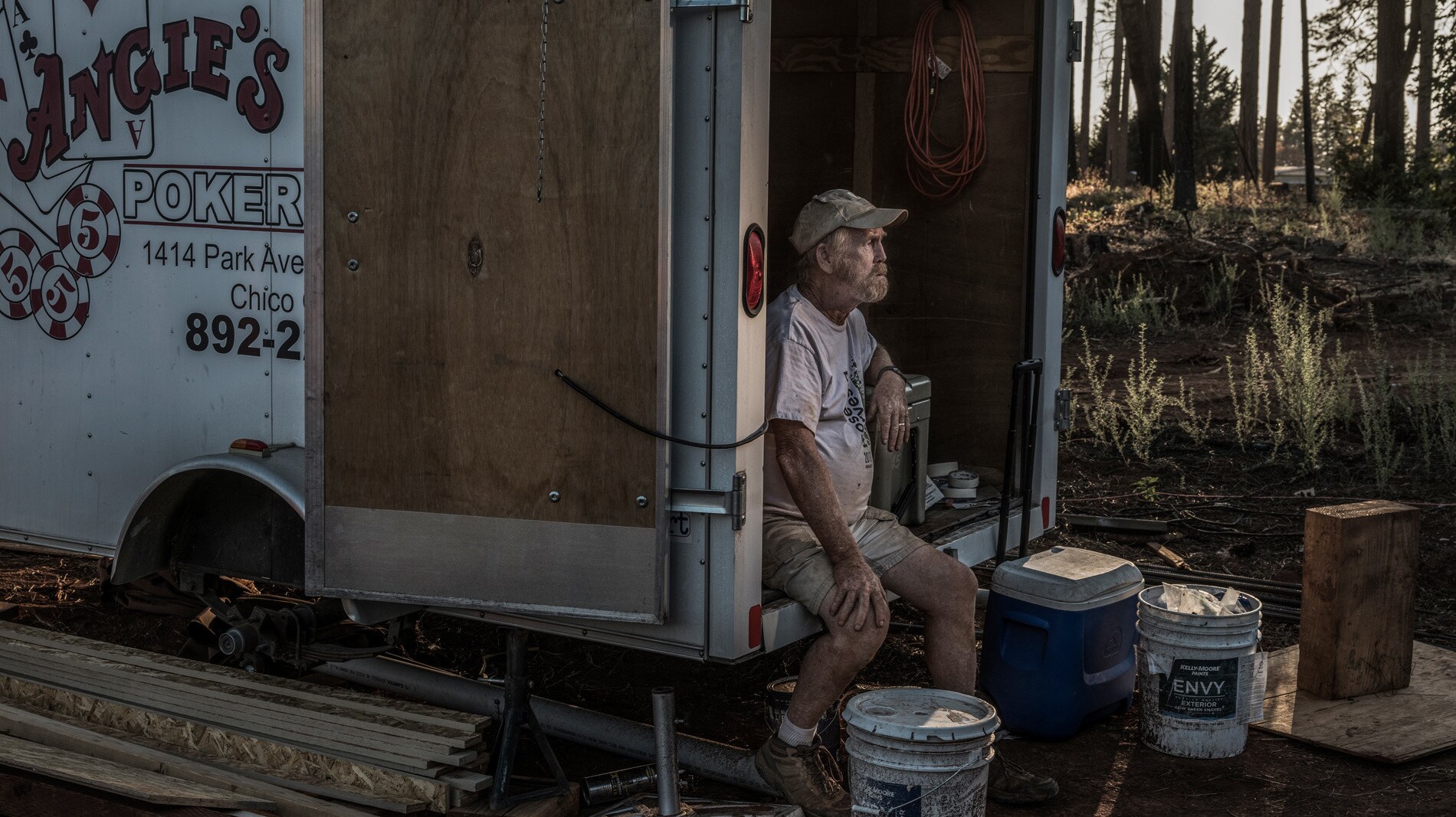 Steve "Woody" Culleton sits in a small storage trailer on his property in Paradise, CA, where he is rebuilding his home. (National Geographic/Pete Muller)