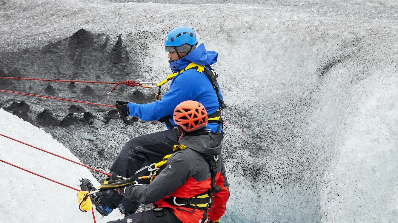 Will Smith and Dwayne Fields going into a hole by ropes on Breidamerkurjokull glacier.  (National Geographic for Disney+/Bragi Þór Jósefsson)