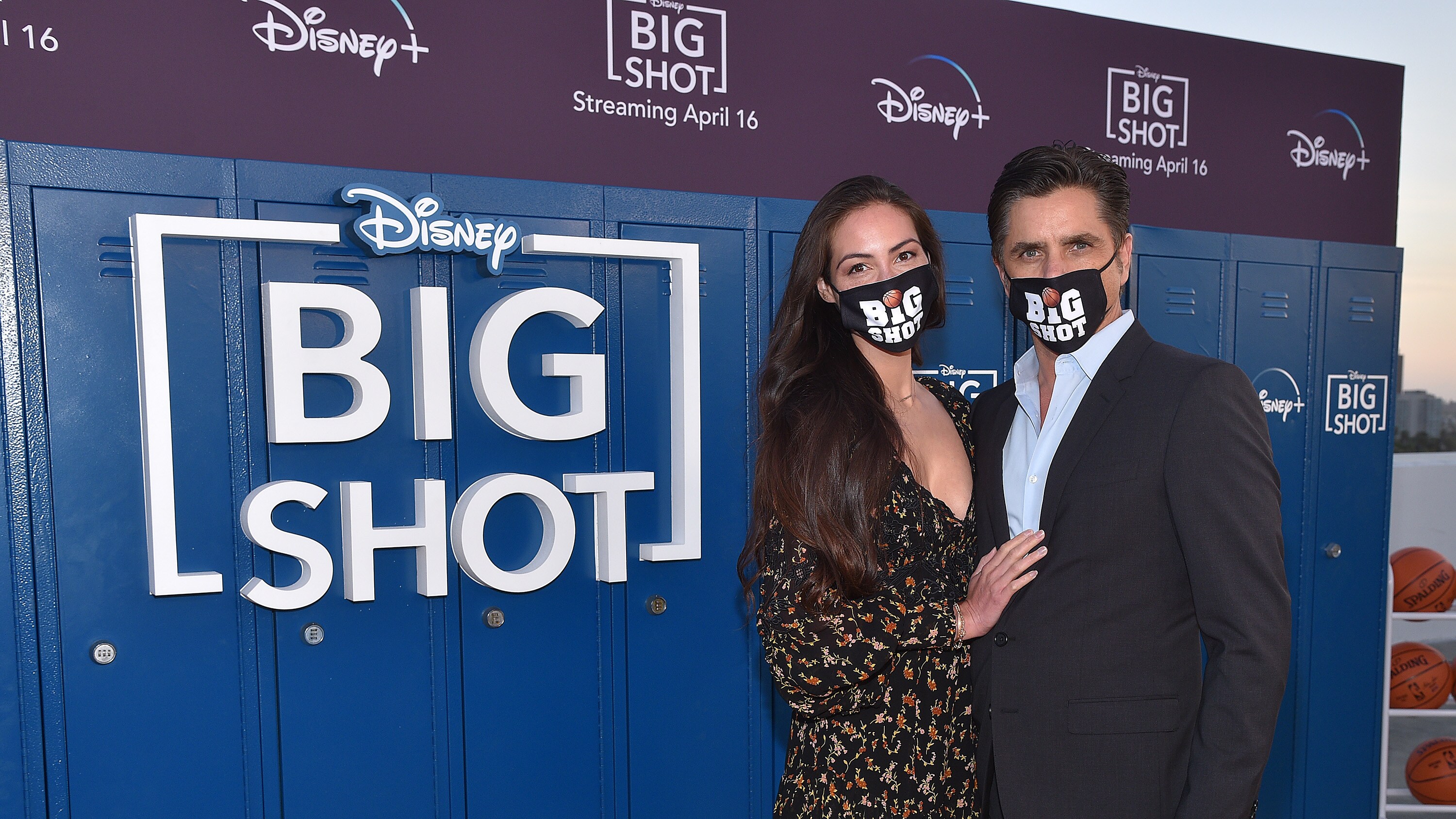 LOS ANGELES, CA - APRIL 14: Caitlin McHugh and John Stamos attend the world premiere drive-in screening of the Disney + original series “BIG SHOT” at The Grove in Los Angeles, California on April 14, 2021. (Photo by Stewart Cook/Disney +/PictureGroup)