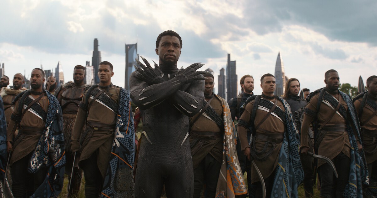 Black Panther, M'Baku, Captain America, and Winter Soldier stand together in Wakanda in a scene from Avengers: Infinity War. 