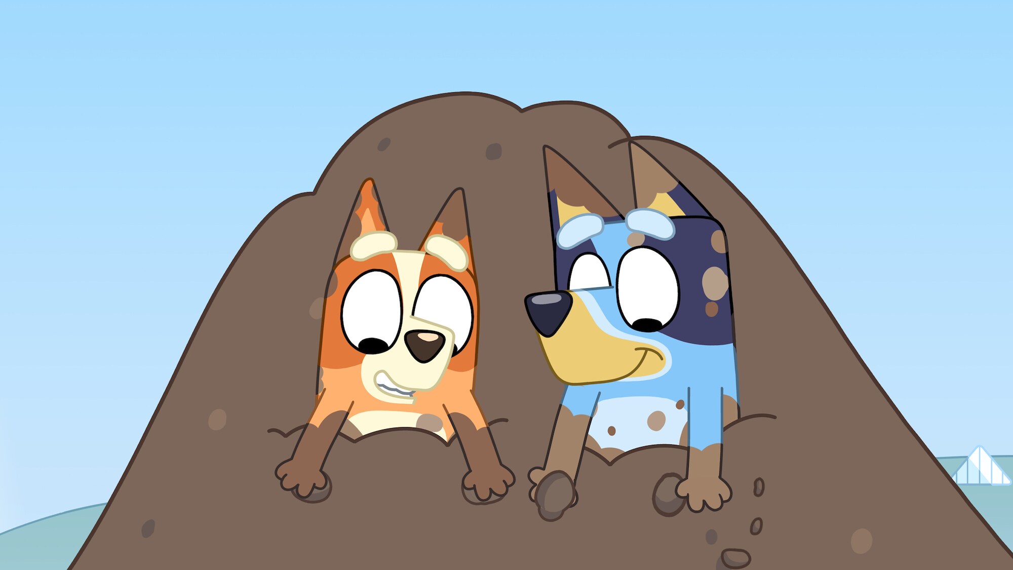 Bluey and Bingo are having a blast playing in a huge pile of dirt!
