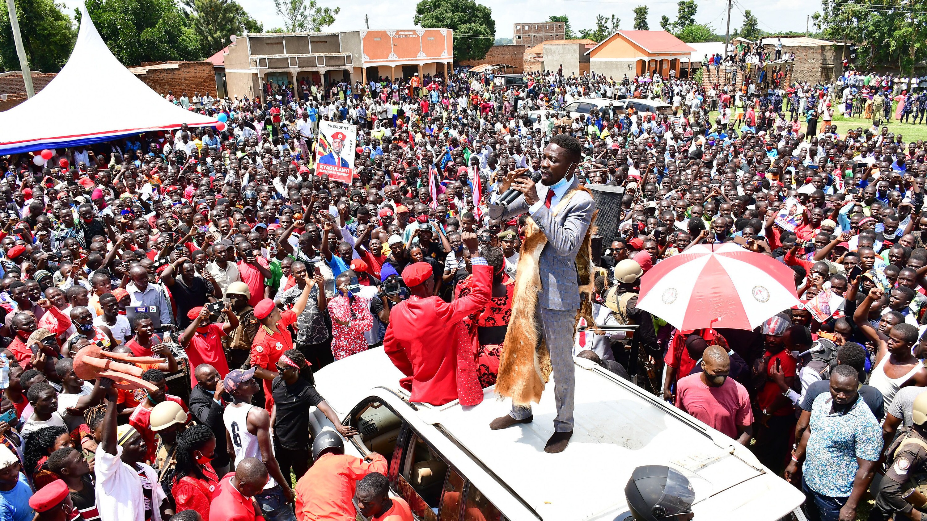 Robert Kyagulanyi Ssentamu (standing on roof of the vehicle), a candidate in Uganda's general elections in 2021 and widely regarded as the closest challenger to incumbent Yoweri Museveni, campaigns in Butaleja district in the country's East on November 17, 2020. (photo credit: Lookman Kampala)