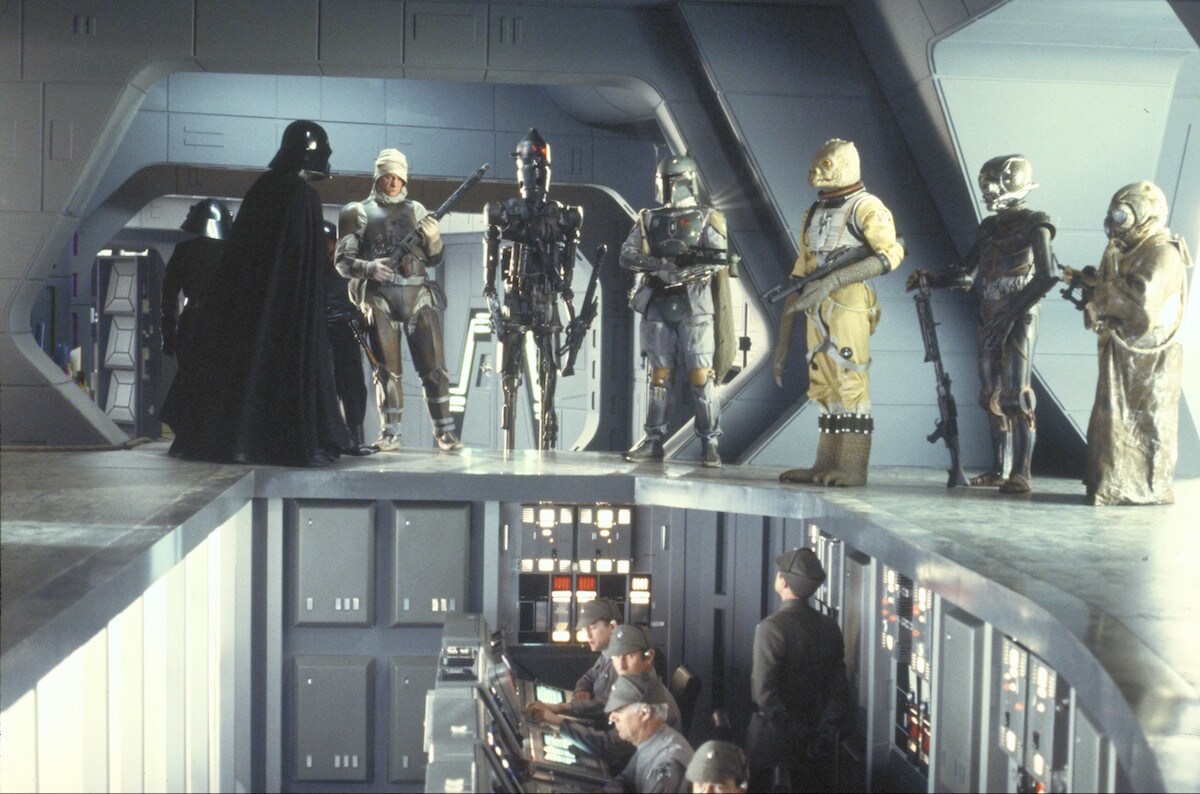 Bossk and other bounty hunters receiving a job from Darth Vader