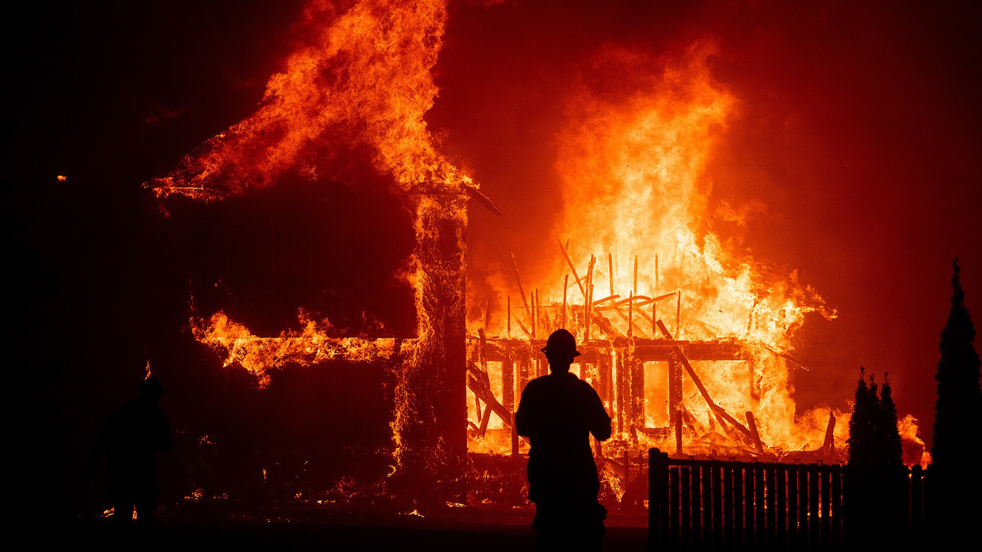 A home burns as the Camp Fire rages through Paradise, California, on Thursday, Nov. 8, 2018. (Photo by Noah Berger)