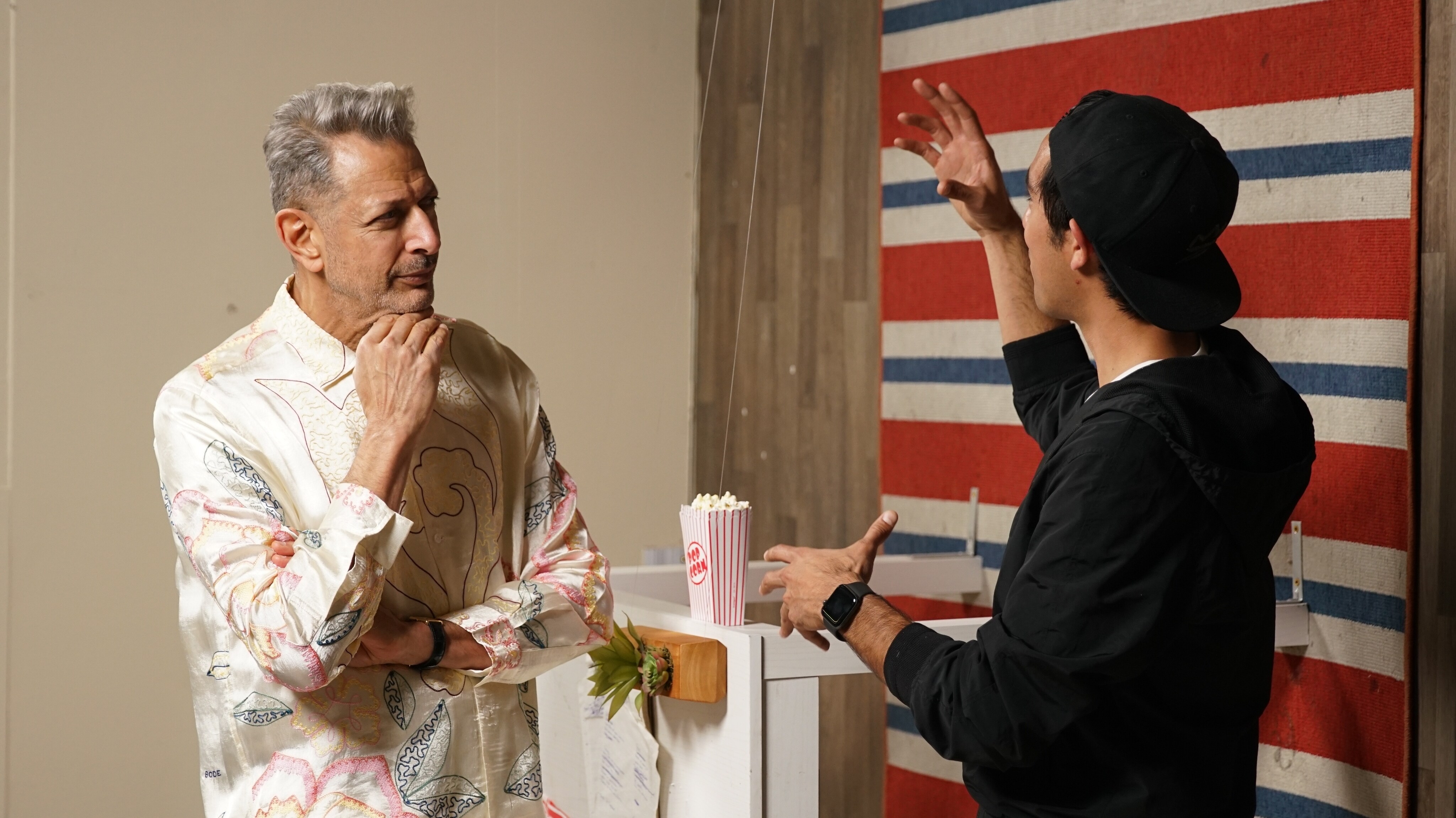Los Angeles, CA - Jeff Goldblum (L) and Zach King (R) with rug and table on the wall behind them. (Credit: National Geographic)