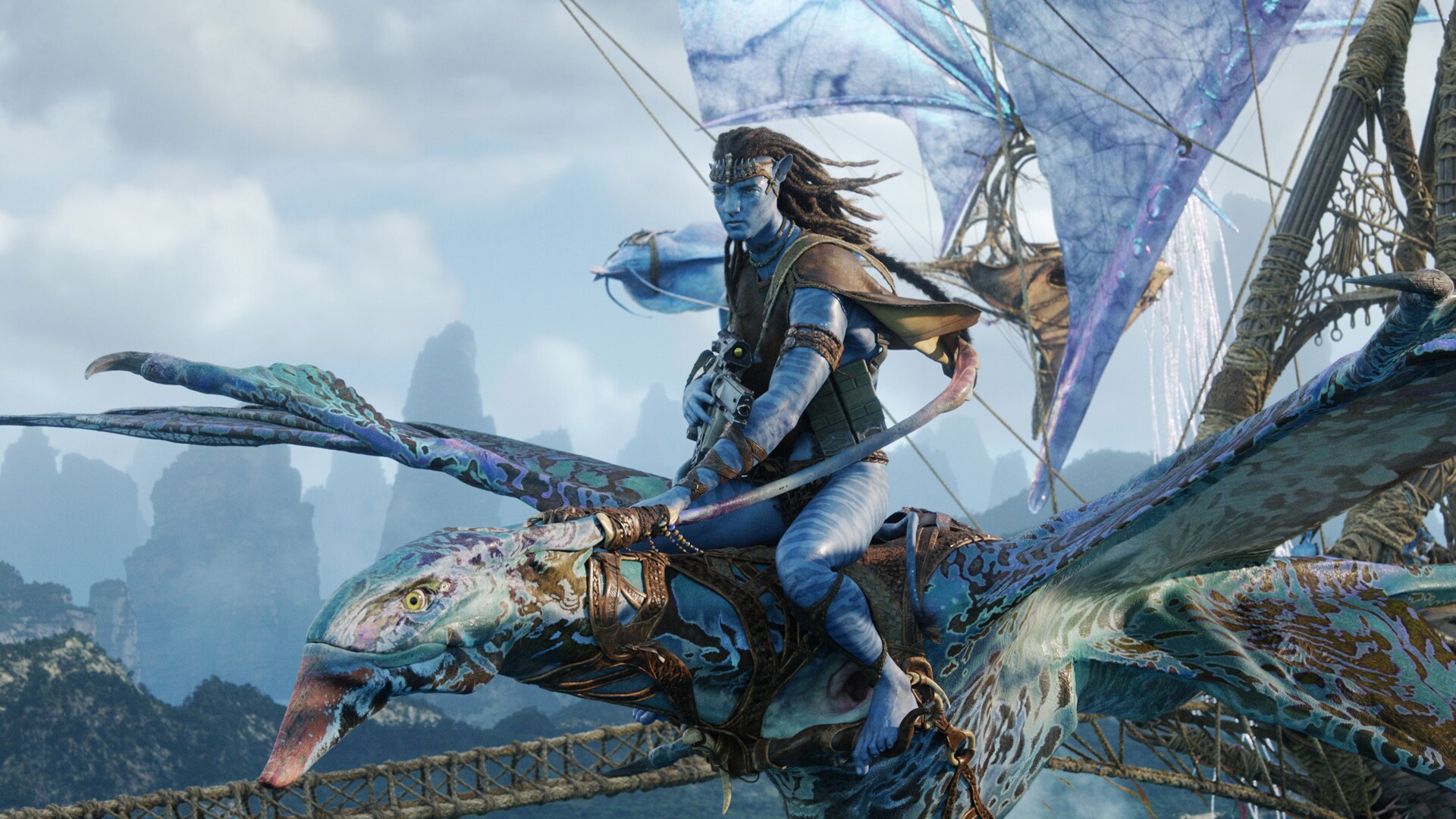 Jake Sully flies through the skies of Pandora on a banshee creature in Avatar: Fire and Ash, gripping its reins with focus and determination.