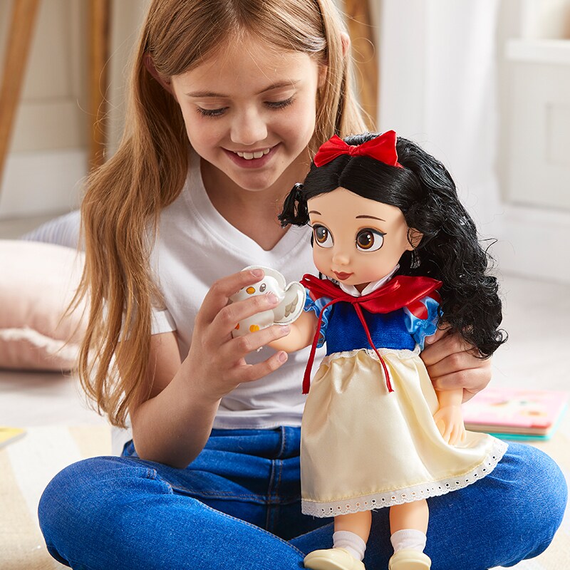 Girl plays with a Snow White Disney Animator Doll